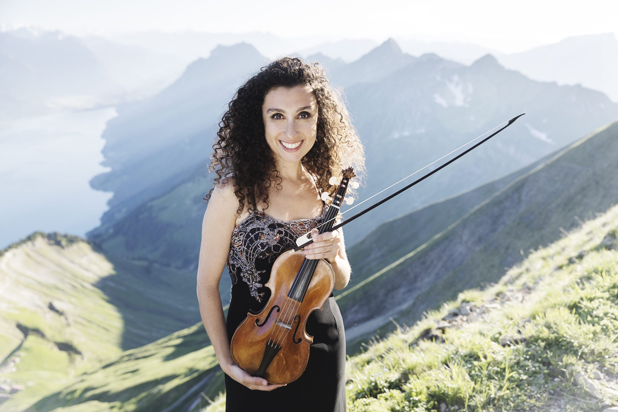 The violinist Chouchane Siranossian can be seen in front of a landscape